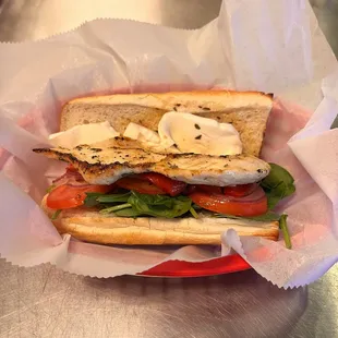 Try our grilled chicken sandwich! Made with baby spinach, tomato, red onions, roasted peppers &amp; fresh mozzarella!