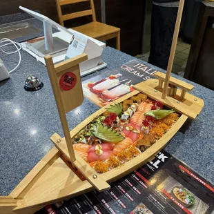 a wooden boat with sushi on it