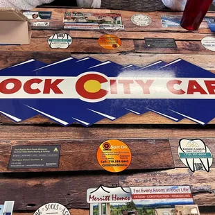 a wooden table covered in stickers