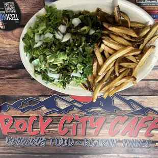 This is a slopper (open face chili covered sandwich) with lettuce, onions and grilled jalapeños on top