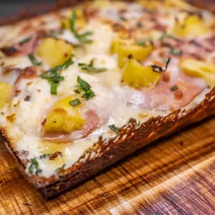 a piece of bread with cheese and pineapples