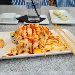 a plate of food and chopsticks