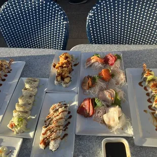 Sashimi platter in the middle, plus a variety of rolls