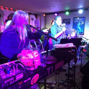  man and a woman playing instruments