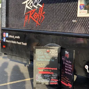 a black food truck parked in a parking lot