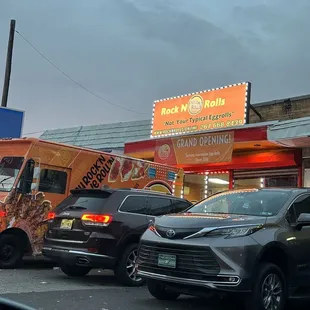 cars parked in front of a food truck