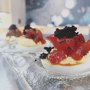 ows deviled eggs topped with blackberries