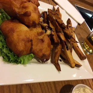 Fish and fries covered with balsamic dressing