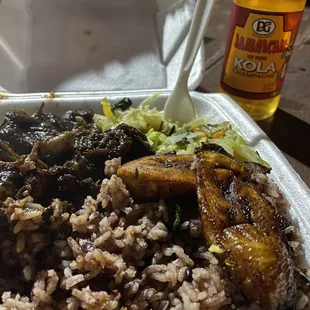 Small plate oxtails with red beans and rice, plantain and cabbage. Plate comes as pictured.