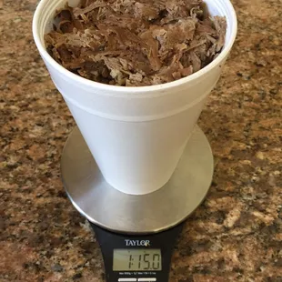 ows a portion of beef being weighed on a scale