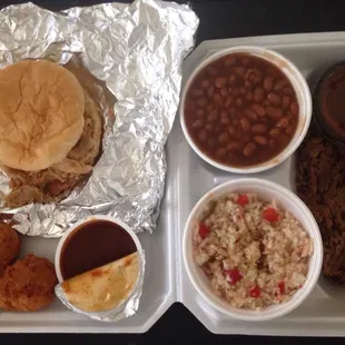 Pulled chicken sandwich, brisket plate (pulled?), baked beans, red slaw, hush puppies.