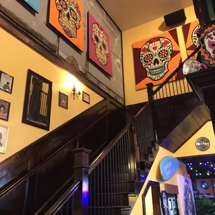 a stairway way with art on the wall