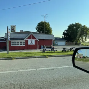 a red building with picnic tables