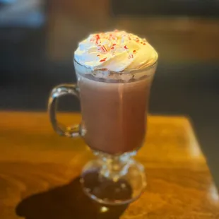 Warm up by our fireplace with our Peppermint Patty winter cocktail! Warm hot chocolate with peppermint Schnapps topped with whipped cream.