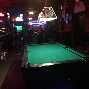 a pool table and neon signs