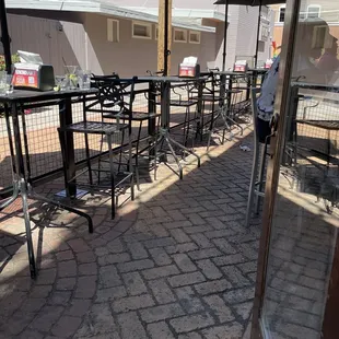 a patio with tables and umbrellas