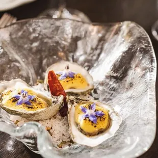 three oysters in a glass bowl
