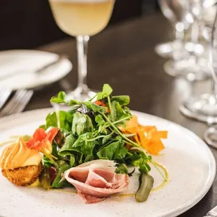 a plate of food and a glass of wine