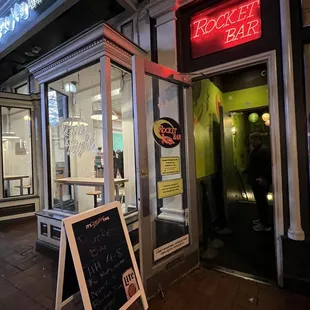 a neon sign in front of a restaurant