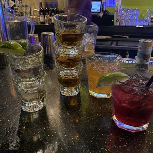 a variety of cocktails on a bar counter