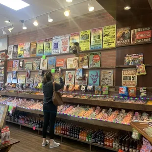 a woman standing in a candy store