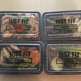 four plastic containers of just fit foods