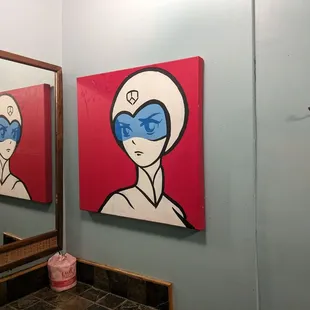 Women's bathroom art.