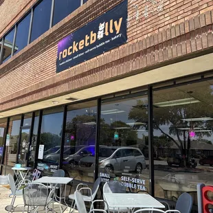 outside of restaurant with tables and chairs