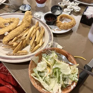 Order of fried catfish with two side: salad and fresh cut fries.