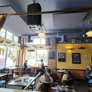 people sitting at tables in a restaurant