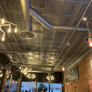 a restaurant with exposed ceilings