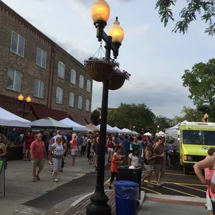 a crowd of people walking down the street