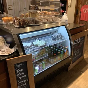 Larger view of baked goods on cooler by the order counter with wifi password (did not work for me) and various merchandise available