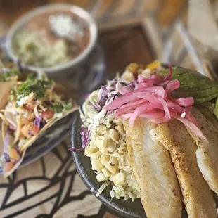 A trio of fish tacos, shrimp, lobster and cod. Blackened fish bowl is the other dish. Ask for the cilantro lime dressing too