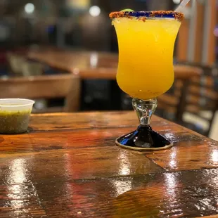 a glass of orange juice on a bar