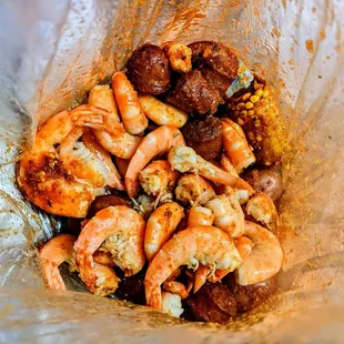 headless shrimp with corn, potato, sausages