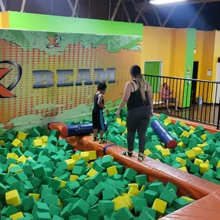 Practice your battle skills on a balance beam with huge foam q-tips