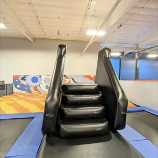 Kids climb up the steps and jump off below