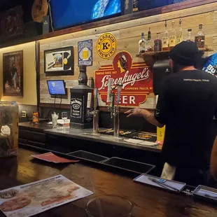 a bartender pouring a drink