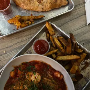 Shrimp zucchini noodle pasta and a calzone
