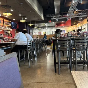 Bar atmosphere with high top tables and booths