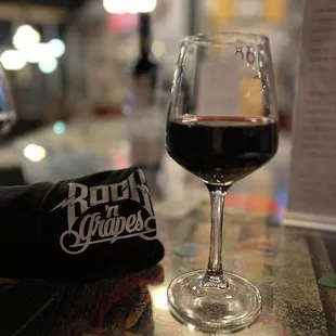 a glass of wine on a bar