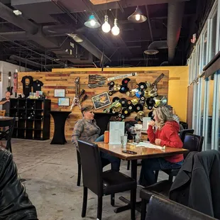 people sitting at tables in a restaurant