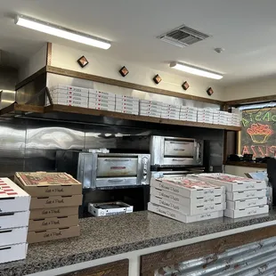 pizza boxes stacked on counter