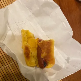 a hot dog in a paper wrapper