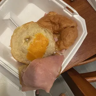 ham, egg, and bread in a styrofoam container