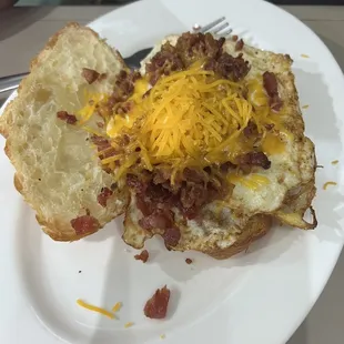 Croissant breakfast sandwich with bacon.