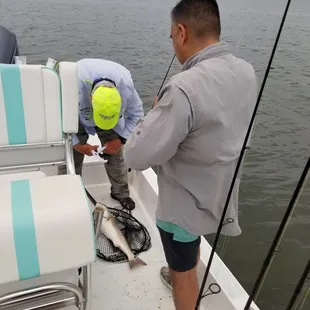Capt Ray helping with our first catch.