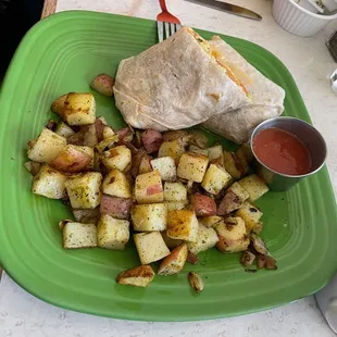 Breakfast burrito with ranchero sauce and home fries