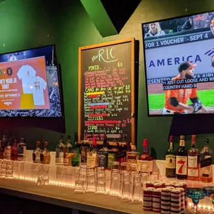 a bar with candles and bottles of liquor